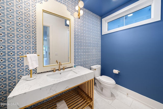 bathroom featuring tile walls, vanity, tile patterned floors, and toilet