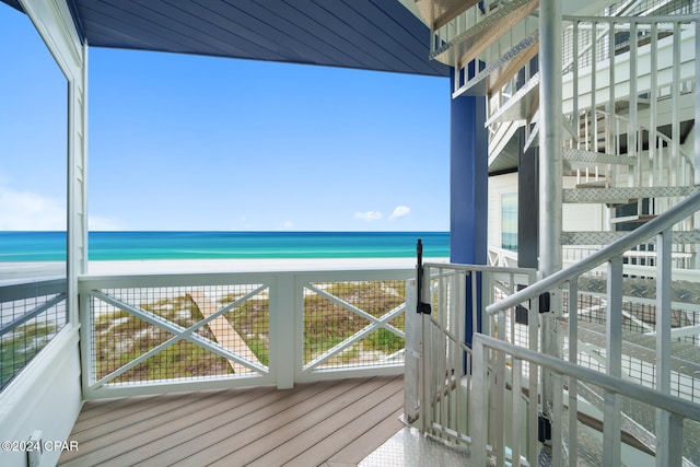 balcony with a beach view and a water view