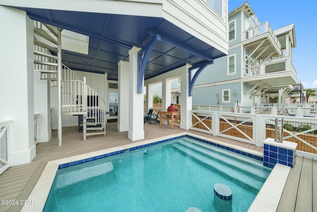 view of swimming pool featuring a deck