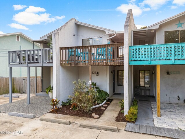 rear view of property with a patio area and a wooden deck