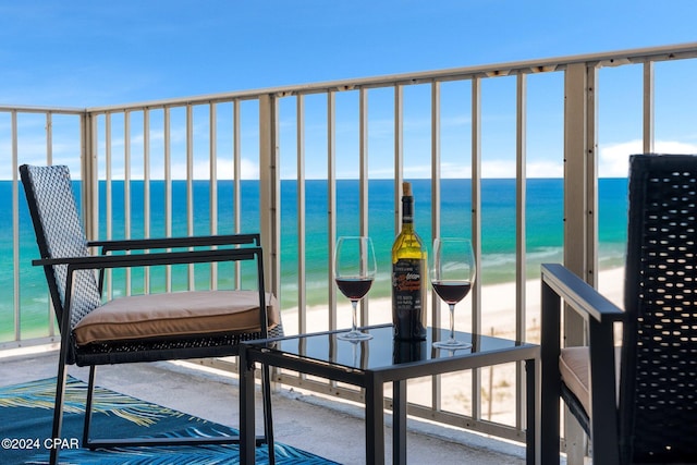 balcony with a water view and a beach view