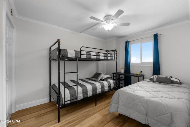 bedroom featuring ceiling fan, wood-type flooring, and ornamental molding