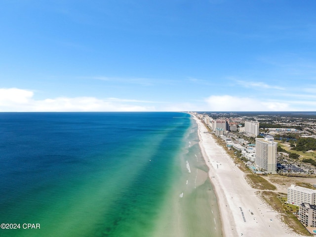 birds eye view of property with a water view and a beach view