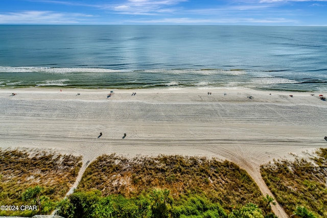 drone / aerial view with a beach view and a water view