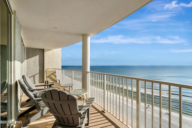 balcony with a beach view and a water view