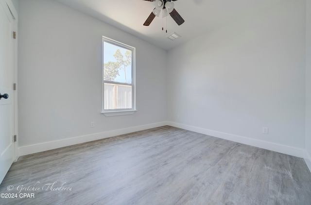 empty room with ceiling fan and light wood-type flooring