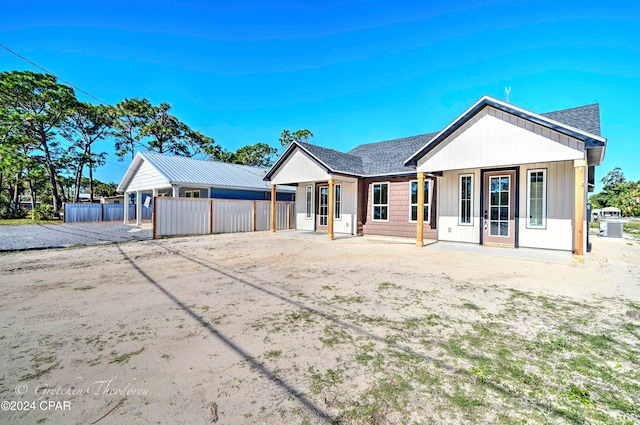 ranch-style house featuring a porch and cooling unit