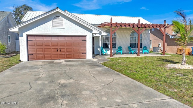 view of front facade with central AC, a garage, and a front yard