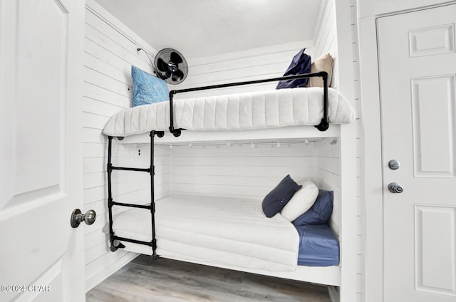 bedroom with hardwood / wood-style floors and a textured ceiling