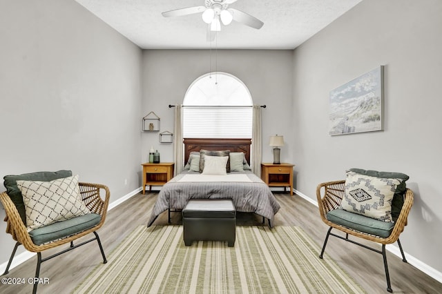 bedroom with wood-type flooring, a textured ceiling, and ceiling fan