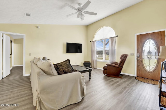 living room with wood-type flooring, a healthy amount of sunlight, and ceiling fan