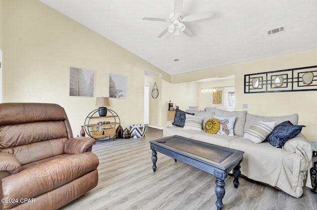 living room with lofted ceiling, ceiling fan, and light wood-type flooring