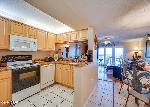 kitchen with sink, ceiling fan, light tile patterned floors, white appliances, and crown molding