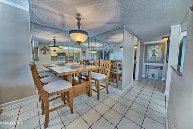 dining room featuring light tile patterned flooring and a textured ceiling