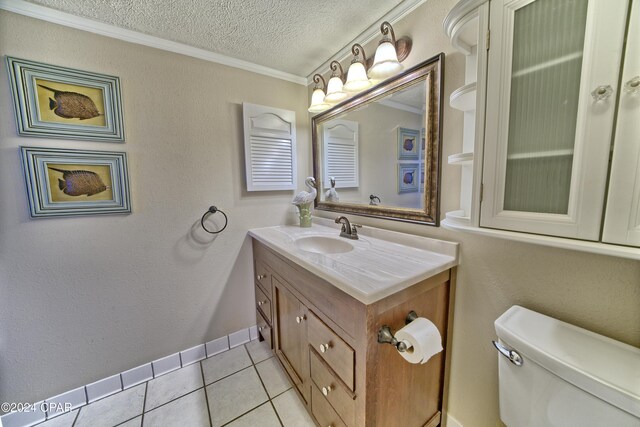 bathroom with tile patterned floors, vanity, a textured ceiling, and crown molding