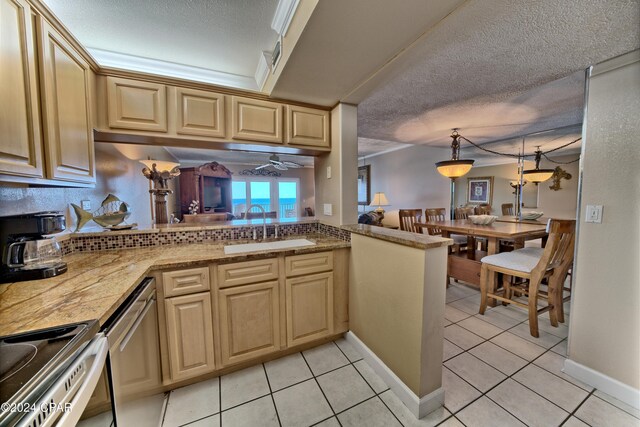 kitchen with appliances with stainless steel finishes, sink, light tile patterned flooring, and a textured ceiling