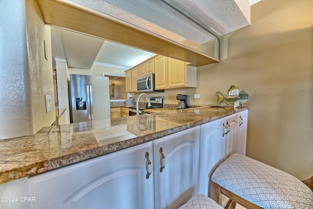 kitchen featuring kitchen peninsula, light stone counters, and stainless steel appliances