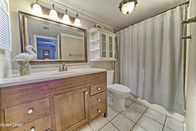 bathroom featuring toilet, a shower with curtain, a textured ceiling, vanity, and tile patterned flooring