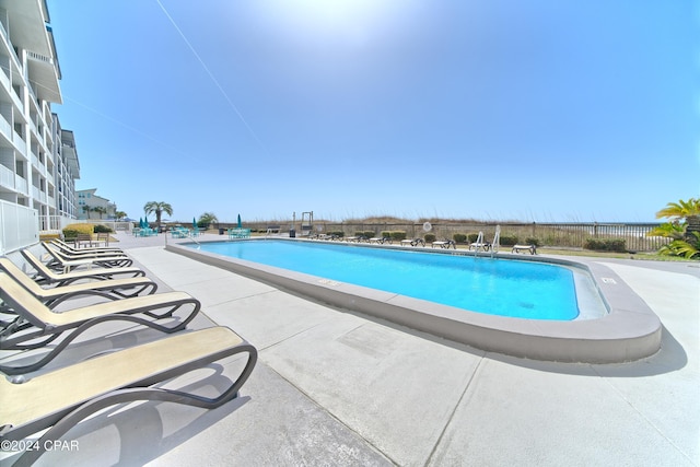 view of swimming pool featuring a patio area