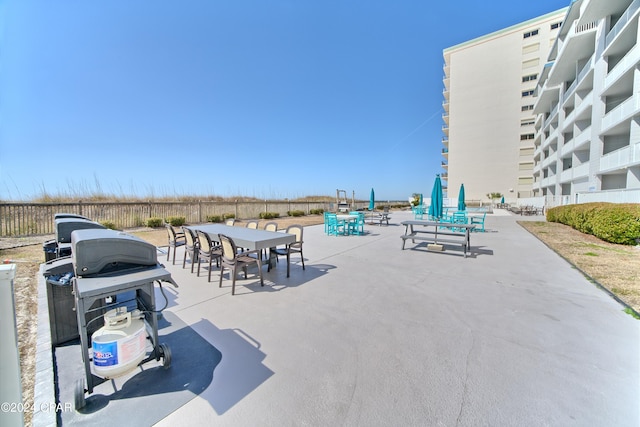 view of patio with area for grilling and a balcony