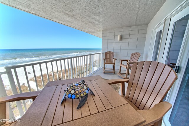 balcony with a view of the beach and a water view