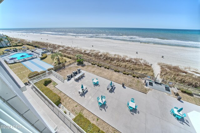 drone / aerial view with a beach view and a water view