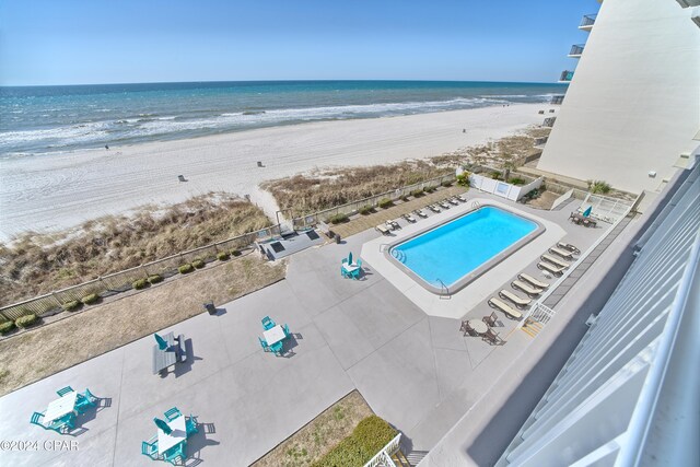 birds eye view of property featuring a beach view and a water view