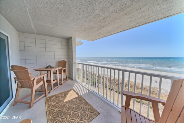 balcony with a beach view and a water view