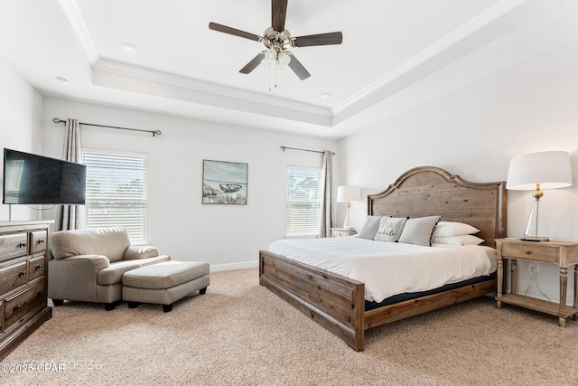 bedroom with a raised ceiling, ornamental molding, and light carpet