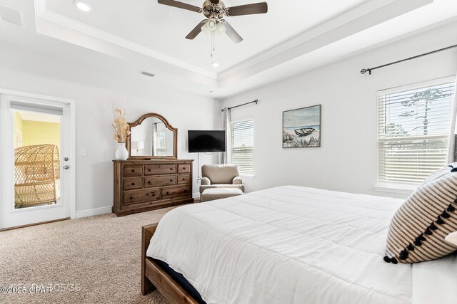 bedroom with baseboards, visible vents, carpet floors, crown molding, and a raised ceiling