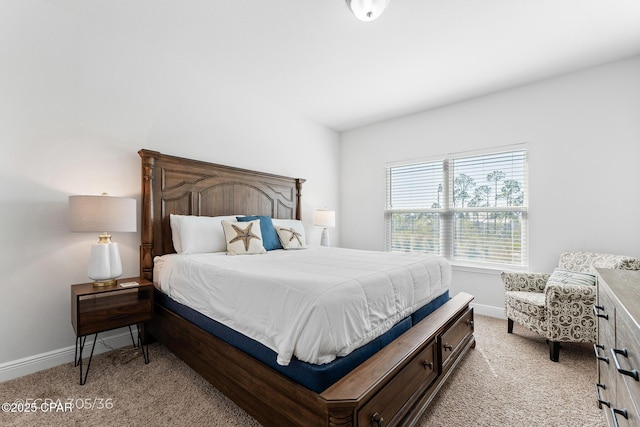 bedroom featuring baseboards and light carpet