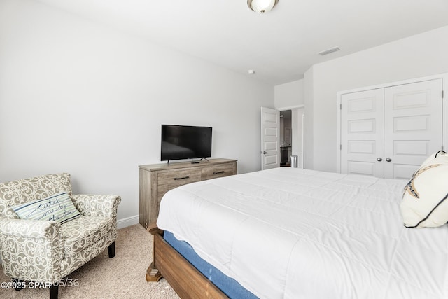 bedroom with a closet, carpet flooring, baseboards, and visible vents