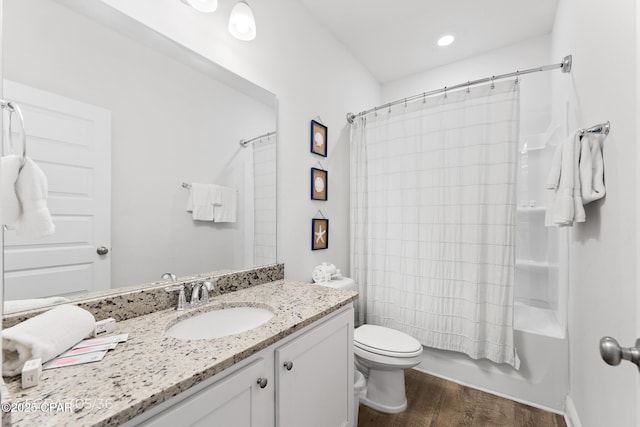 bathroom with toilet, vanity, shower / bath combo with shower curtain, and wood finished floors