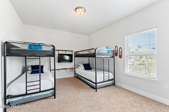 carpeted bedroom featuring baseboards