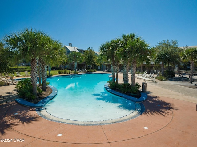 community pool with a patio area