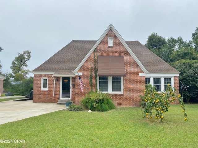 2936 Russ St, Marianna, FL 32446 - tudor house with brick siding, a front yard, and a shingled roof