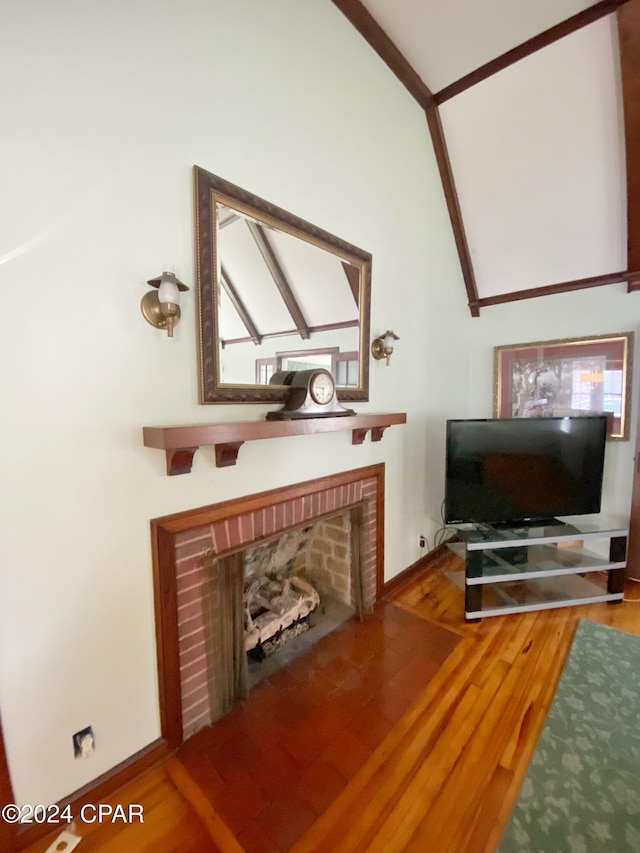 living room with hardwood / wood-style floors, a fireplace, and vaulted ceiling