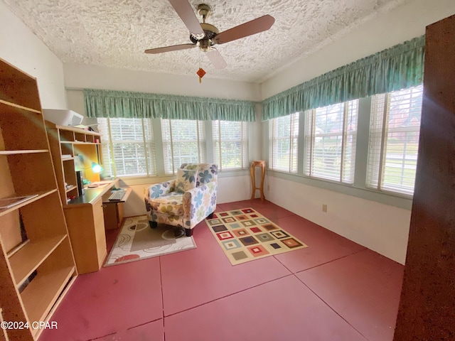 sunroom / solarium with a wealth of natural light and ceiling fan