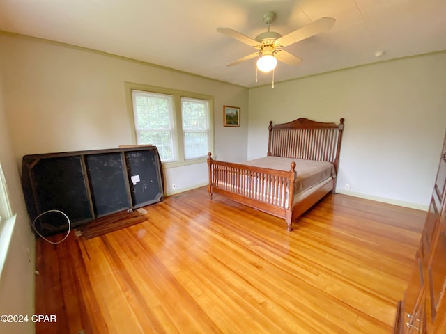 bedroom with hardwood / wood-style flooring and ceiling fan