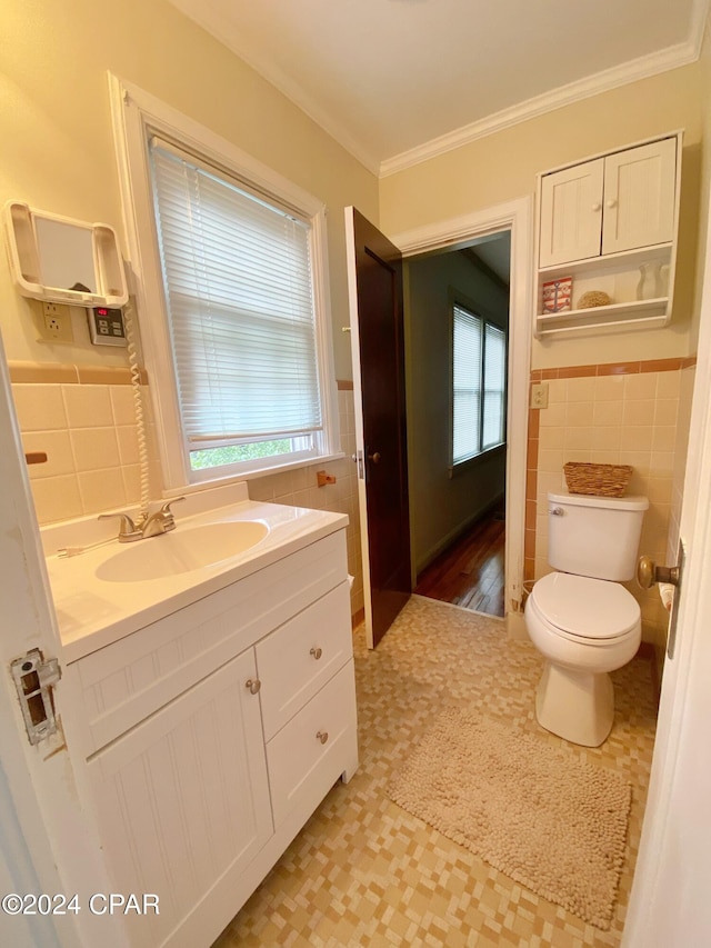 bathroom with ornamental molding, a wealth of natural light, and tile walls