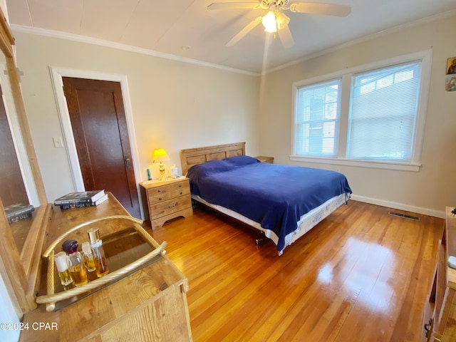 bedroom featuring wood-type flooring, ceiling fan, and crown molding