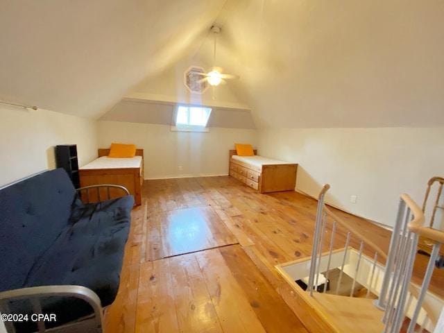 additional living space with light hardwood / wood-style floors, ceiling fan, and vaulted ceiling