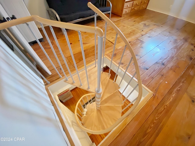 stairs featuring hardwood / wood-style floors