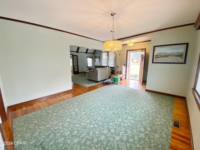 interior space featuring an inviting chandelier, hardwood / wood-style flooring, and ornamental molding