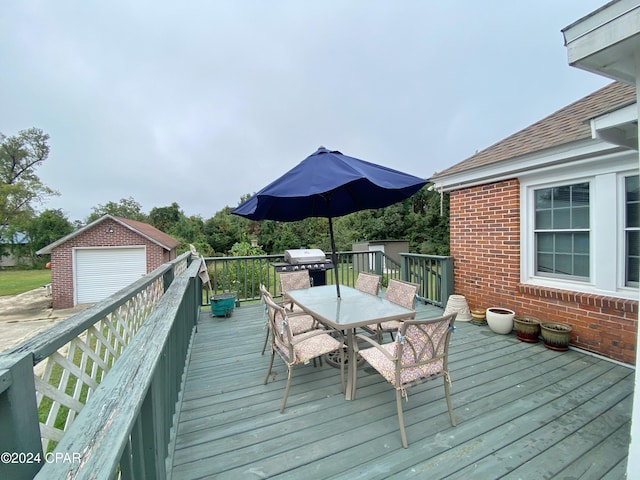 wooden deck featuring a garage and an outbuilding