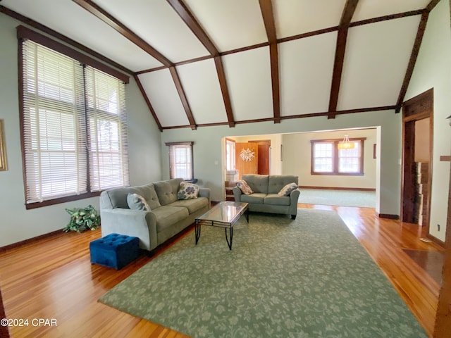 living room featuring lofted ceiling with beams, hardwood / wood-style flooring, and plenty of natural light