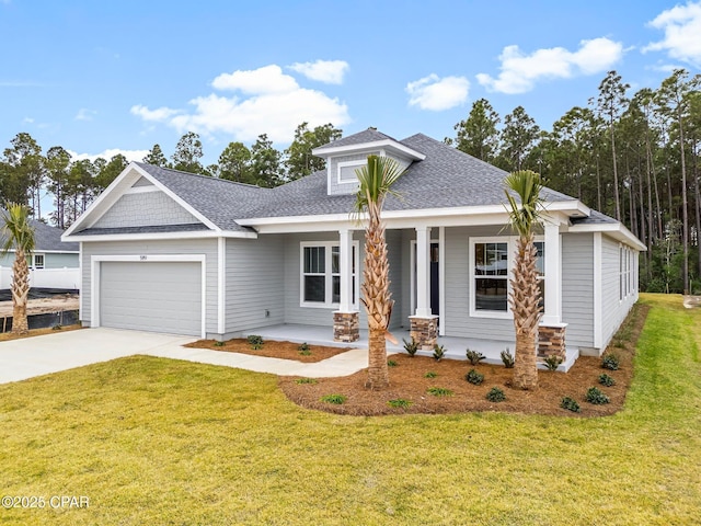 view of front of property with a garage, a porch, and a front yard