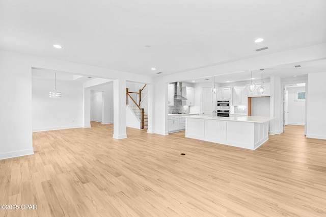 unfurnished living room with light hardwood / wood-style floors