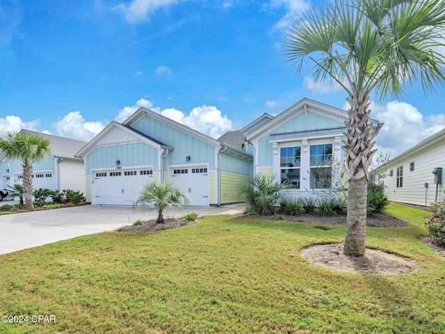 view of front of home with a garage and a front lawn