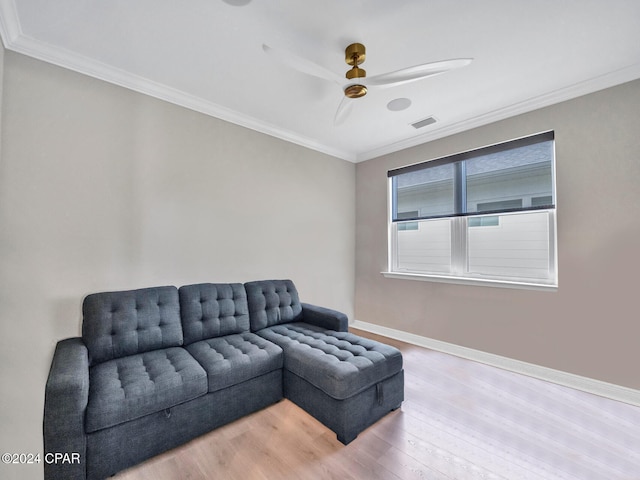 living room featuring ceiling fan, light hardwood / wood-style floors, and crown molding